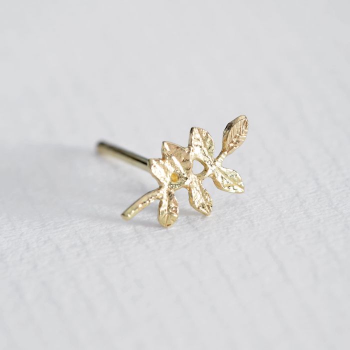 Alex Monroe gold leaf stud earring, angled front view