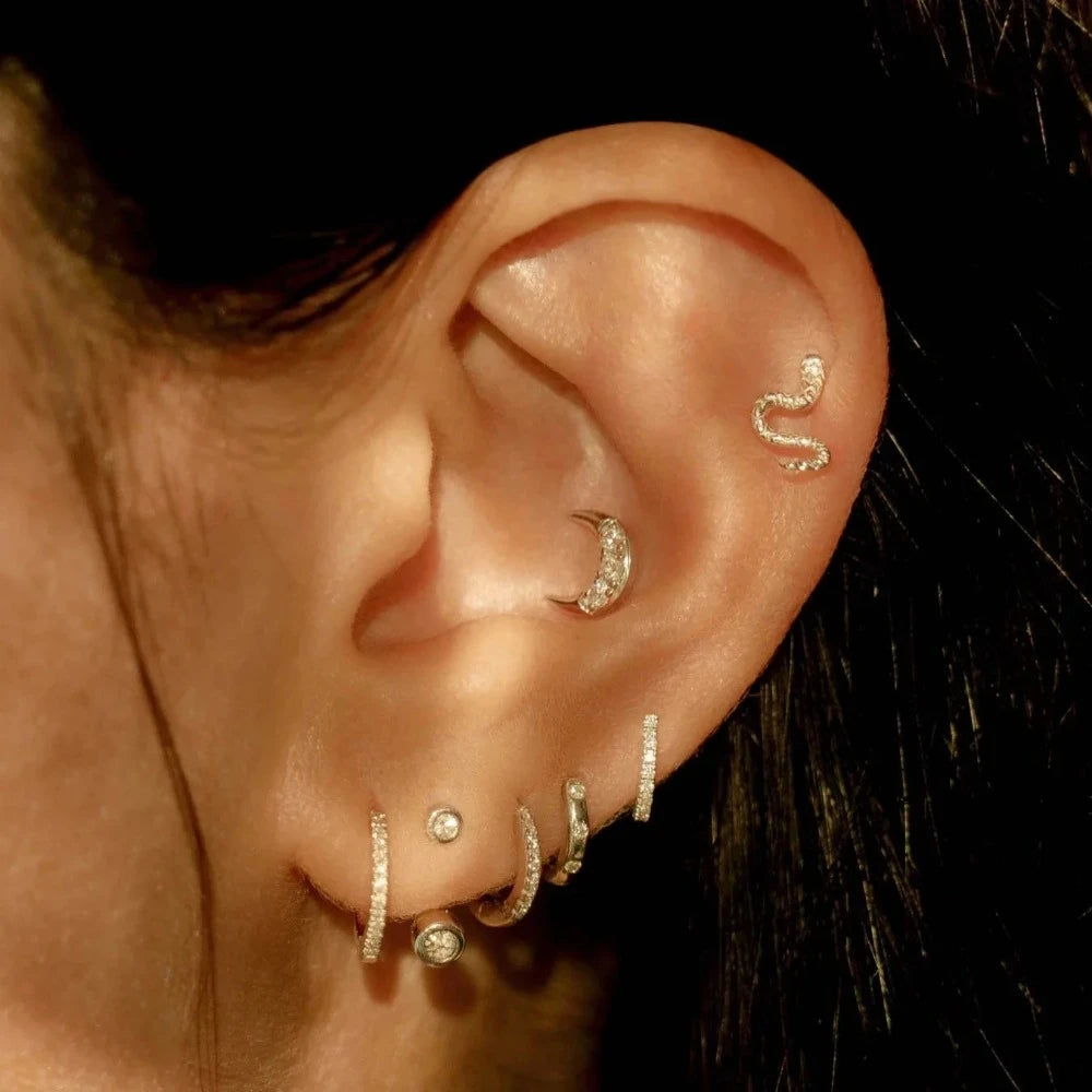 Pamela Love gold snake stud earring, on model front view