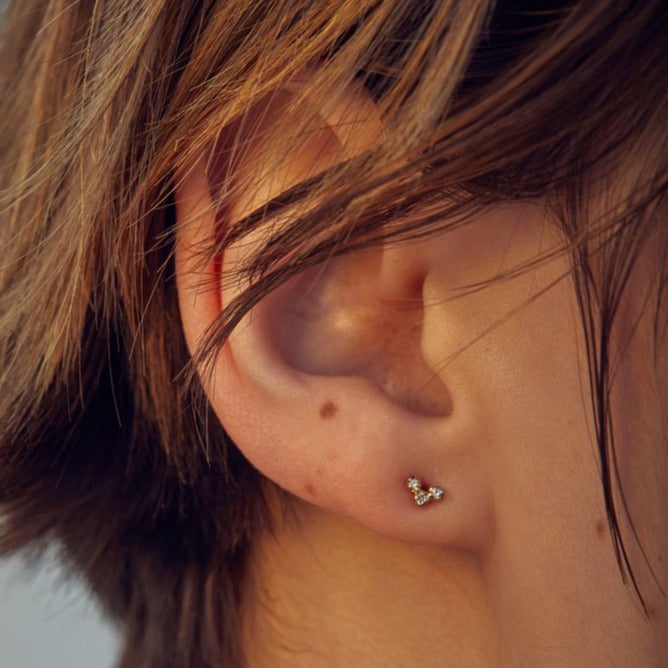 Wwake gold stud earrings with 3 diamonds, front view