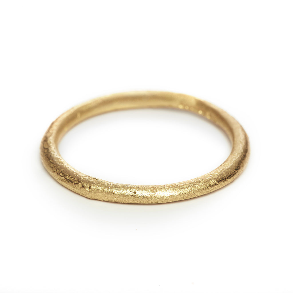 A classic narrow ladies' wedding band with an organic textured finish.