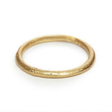 A classic narrow ladies' wedding band with an organic textured finish.