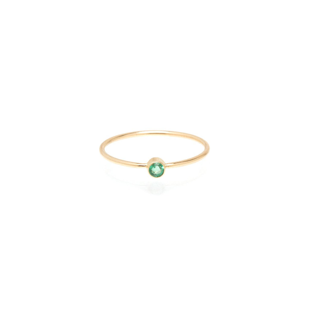 Zoe Chicco gold ring with tiny emerald, front view