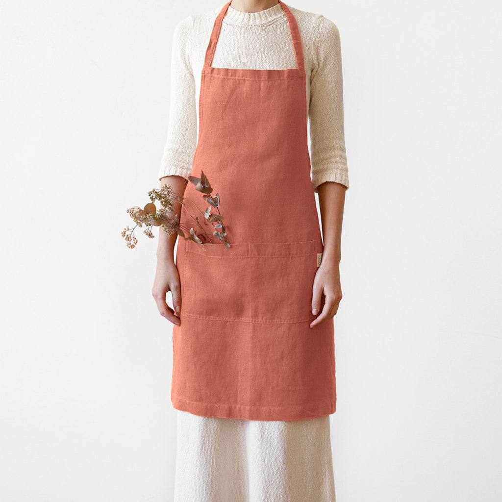 Linen Tales pink apron on model, front view