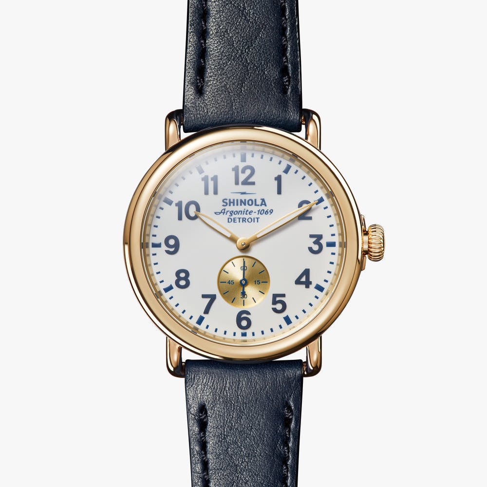 Shinola white and gold watch with black leather strap, front view