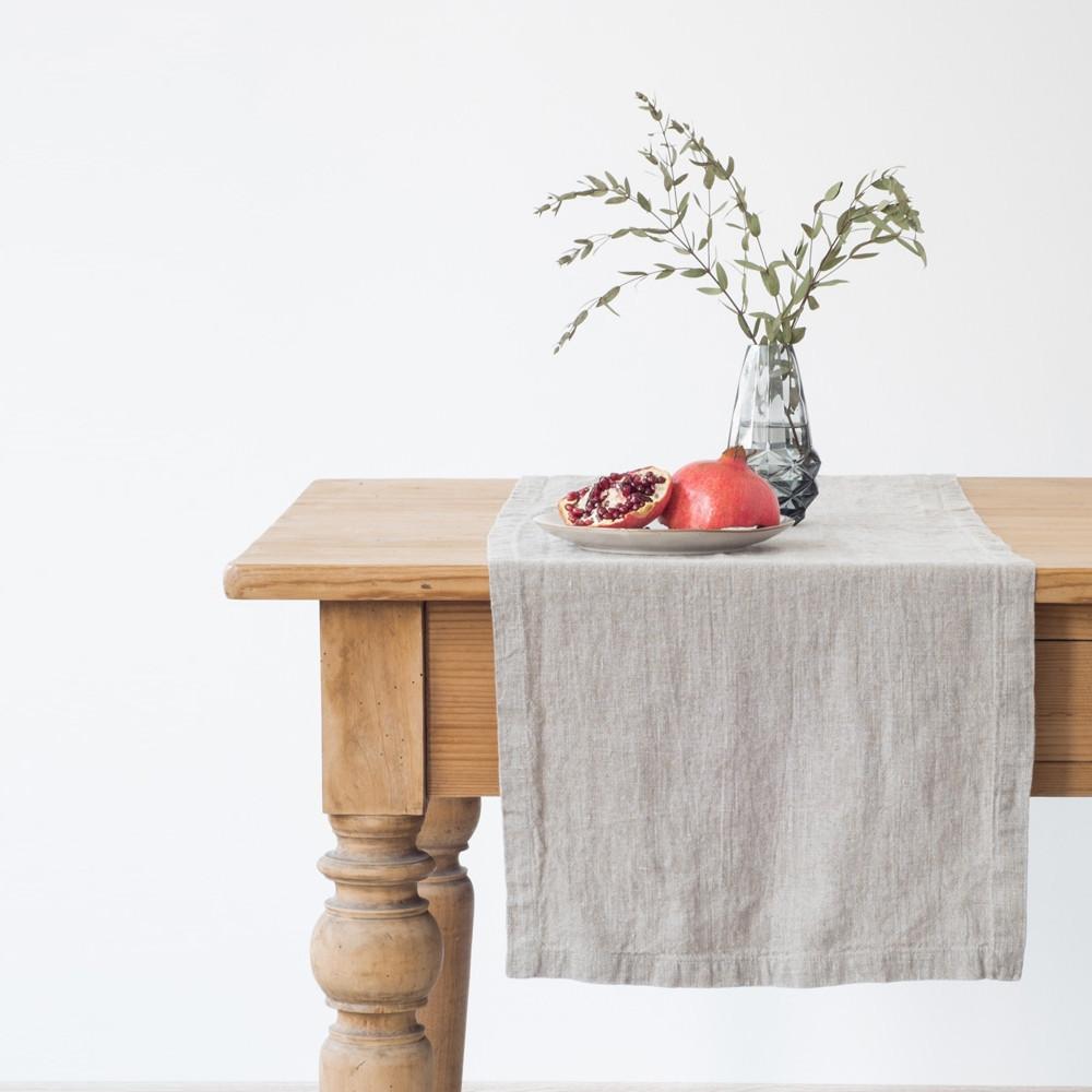 Linen Tales beige table runner on table with fruit and a vase, front view