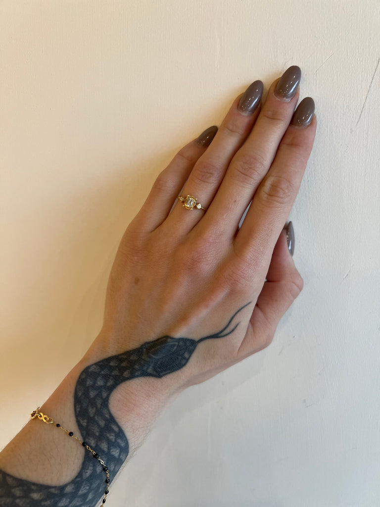 Megan Thorne gold rectangular ring with diamonds on model, top view