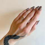 Communion by Joy open frame gold ring with diamonds on model, front view