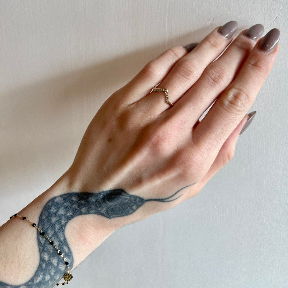 Communion by Joy gold triangle ring with diamonds on model, front view