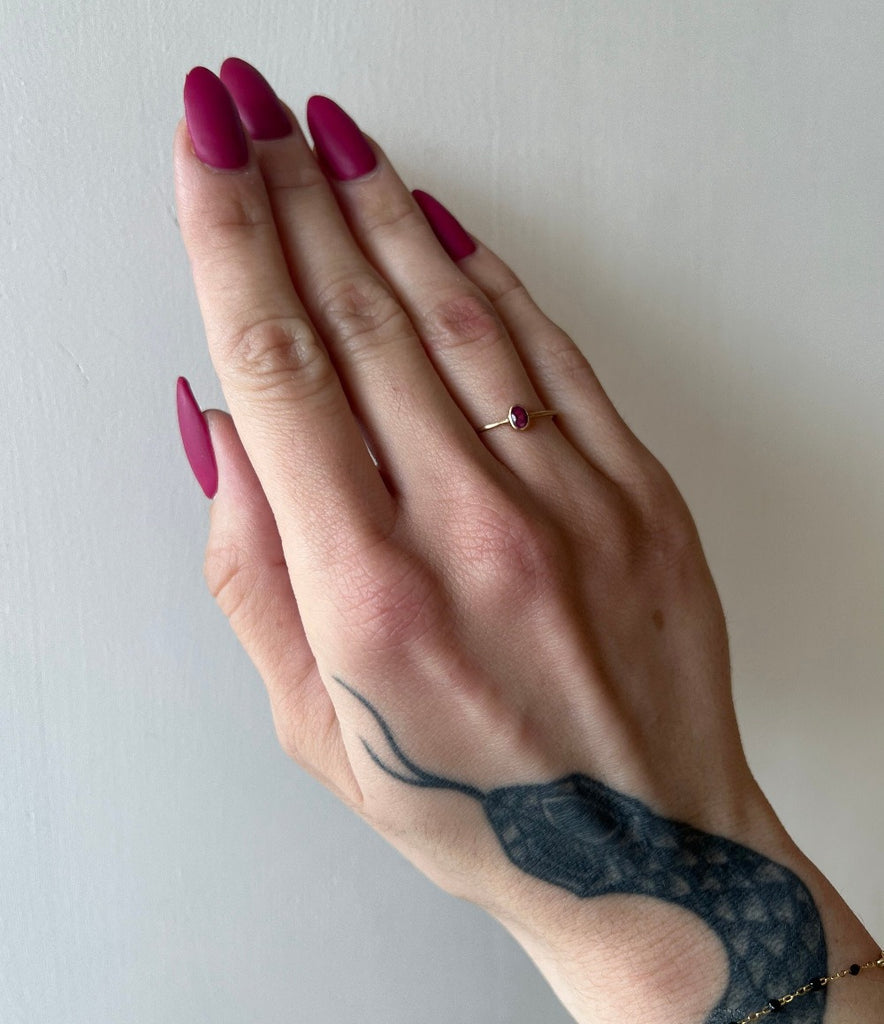 Margaret Solow gold ring with oval ruby on model, top view