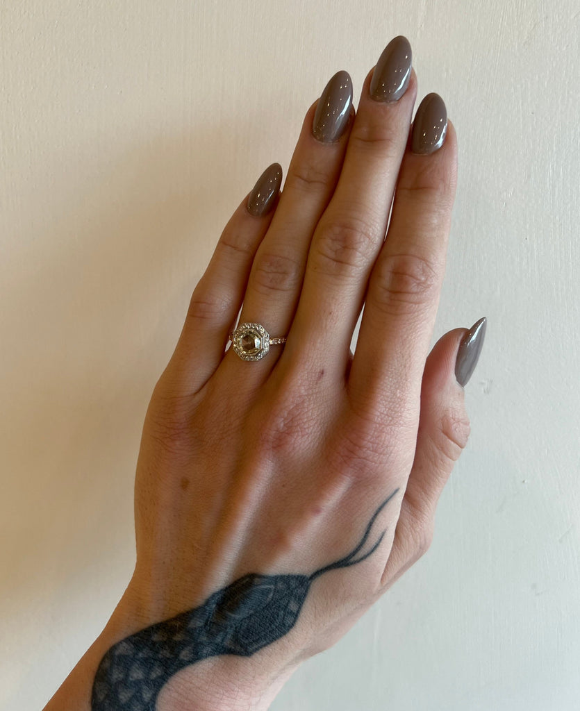 Single Stone rose gold and platinum ring with diamonds on model, top view